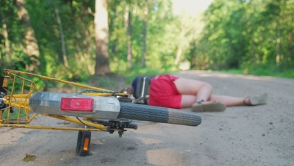 Young Injured Unconscious Caucasian Girl Cyclist Laying on Ground Rural Road After Being Hit by Car