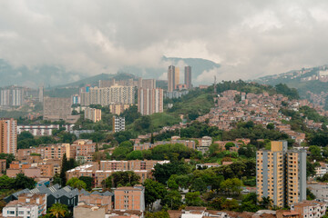 Fototapeta premium Panoramic view of Medellin, Colombia, with a cloudy weather and the Andes Mountains in the background.