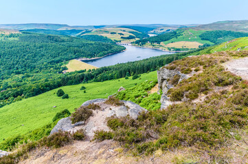 A view from top of Bamford Edge towards the wooded shore of Ladybower reservoir, UK in summertime