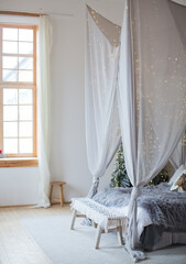Christmas scandinavian bedroom with white canopy © aprilante