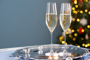 Glasses with champagne near Christmas tree