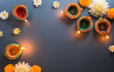 Happy Diwali - Clay Diya lamps lit during Diwali, Hindu festival of lights celebration. Colorful...