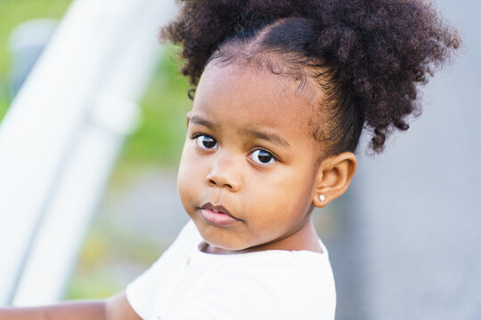 Close up portrait of adorable mixed race baby girl kid.