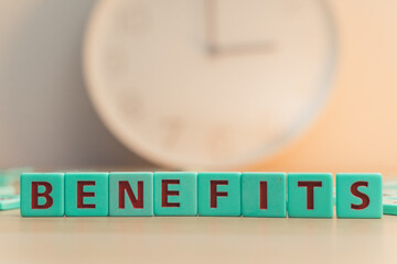 The word BENEFITS made of colorful scrabble tiles. 