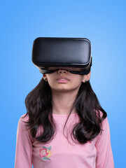 VR glasses , little girl with virtual reality headset. Innovation technology and education concept. Funny girl using a virtual reality headset isolated on blue  background