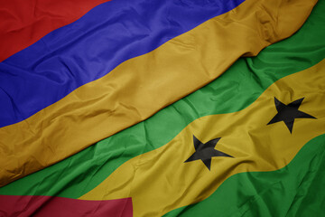 waving colorful flag of sao tome and principe and national flag of armenia.