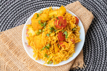 Vegetable pulao recipe made with basmati rice and mix vegetables served in a round plate
