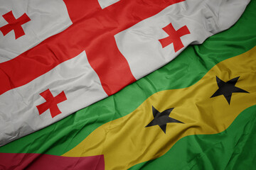 waving colorful flag of sao tome and principe and national flag of georgia.