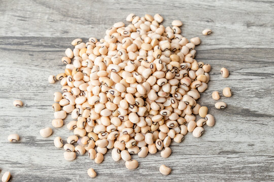 Black eye beans (cowpea) or lobia phalli on wooden texture background.