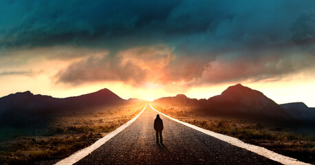 silhouette of a man on the road, concept of uncertainty and obscurity of future - obrazy, fototapety, plakaty
