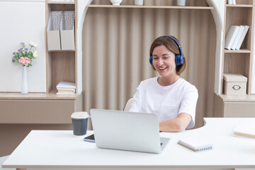 Young attractive woman in headphones studying online at home. Distance education concept	