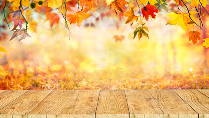 Naklejka na ściany i meble Wooden table with orange leaves autumn background