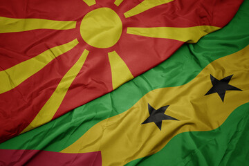 waving colorful flag of sao tome and principe and national flag of macedonia.