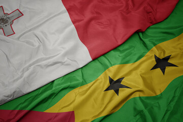 waving colorful flag of sao tome and principe and national flag of malta.