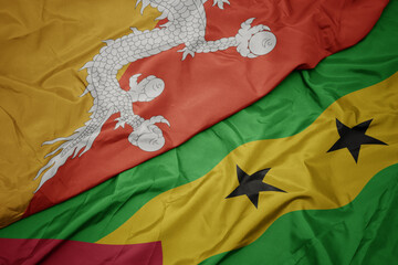 waving colorful flag of sao tome and principe and national flag of bhutan