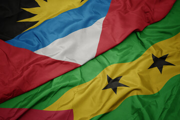 waving colorful flag of sao tome and principe and national flag of antigua and barbuda.