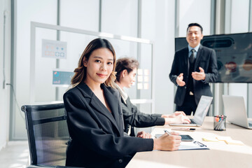 Successful asian businesswoman working and looking camera in a meeting room.