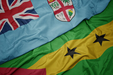 waving colorful flag of sao tome and principe and national flag of Fiji .