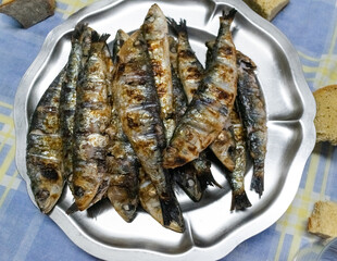 Grilled sardines on a metal platter