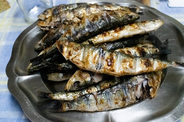 Grilled sardines on a metal platter