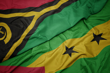 waving colorful flag of sao tome and principe and national flag of Vanuatu .