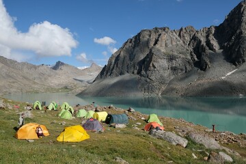 Colorful tents on bank of Lake Ala-Köl (Ala-kol, Ala-kul) in Tien Shan mountains in west of...