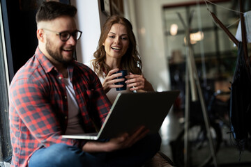 Young happy couple. Boyfriend and girlfriend drinking coffee together.