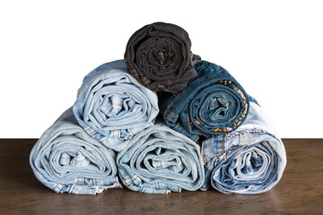 Isolate Jeans of different types, which are overlapping each other, stacked on the wooden floor as art.