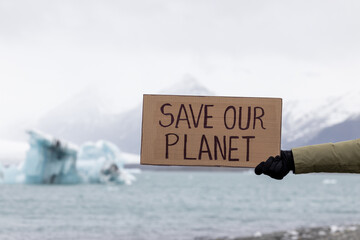 Activist holds a sign with an important message to humanity 