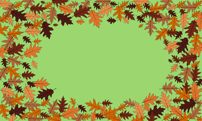 Scattering of autumn oak leaves framing a delicate green space. With copy space