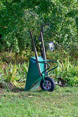 Green wheel barrow standing in garden Kumla Sweden