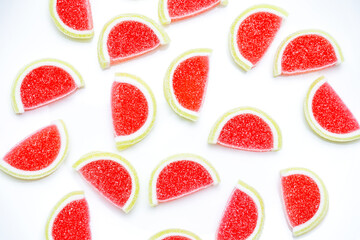 Jelly candies. Top view of watermelon jelly candies sprinkled with sugar on a blue background. Watermelon marmalade. Selective soft focus.Bright summer background.