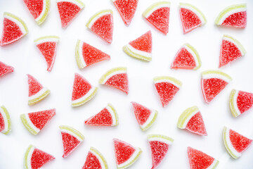 Jelly candies. Top view of watermelon jelly candies sprinkled with sugar on a blue background. Watermelon marmalade. Selective soft focus.Bright summer background.