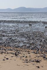 It is a beach with tidal flats.