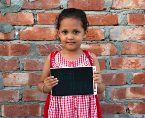 14 September Happy Hindi Diwas or Hindi Language Day. Girl or student showing board.