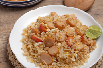 Sausage fried rice with egg and vegetables in white plate