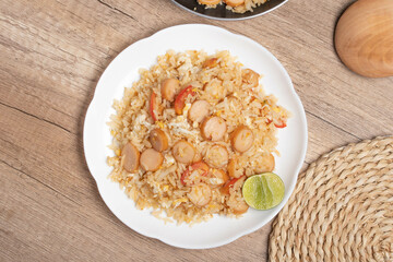 Sausage fried rice with egg and vegetables in white plate