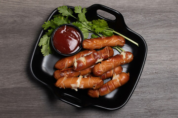 Cheese hot dog with tomato sauce. Dark tone.