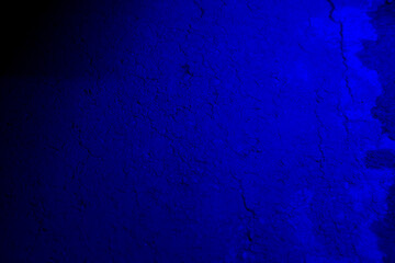 Blue neon color light on textured background.