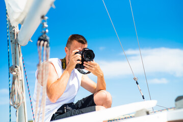 Man photographer yacht on the sea