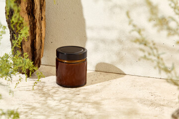 Empty jar for cosmetics. Mockup for natural cosmetics. Aesthetic composition with aromatic candle...