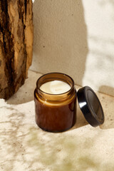 Aesthetic composition with aromatic candle in jar. Mockup soy wax candle in natural style. Scented...