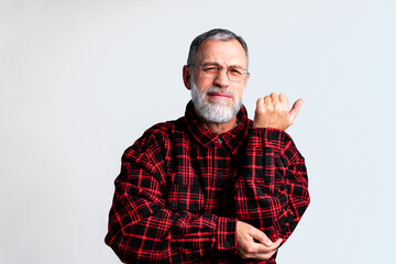 Portrait of mature man isolated on grey background suffering from severe body ache, closing eyes to relieve pain