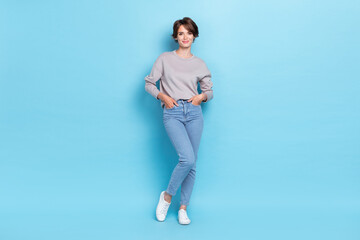 Full length photo of positive lady dressed fashionable nice clothes satisfied new collection hand pocket isolated on blue color background