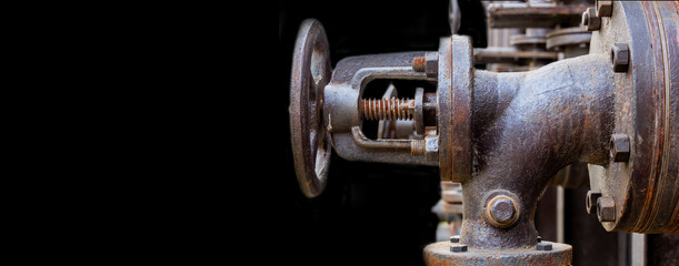 Industrial, machine scene. Steel, rusty valve and bolts on a dark background. Banner Copy space