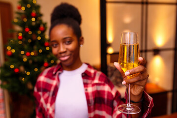latin hispanic woman making a toast congratulations at christmas tree background