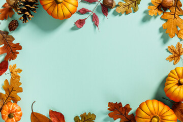 Autumn background creative layout with decorative small pumpkins and autumn leaves