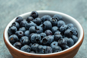 fresh ripe blueberries in bowl on table close up. banner, menu, recipe place for text, top view