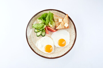fried egg with toasts and salad