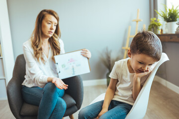 Woman social worker talking to boy. Child psychology, mental health. Parenthood and child...